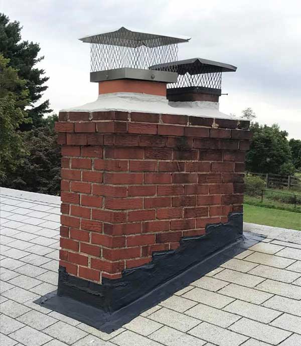 Traditions Chimney Sweeps stock photo of flashing repair. New Flashing Repair - with two caps on chimney.