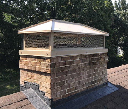 Traditions Chimney Sweeps stock photo of water beading on bricks. Water Beading on bricks after application of ChimneySaver with trees in background.